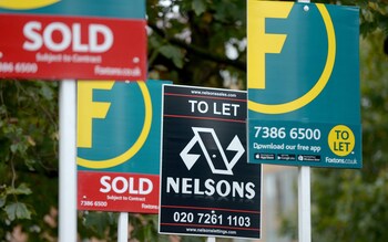 Letting and estate agents signs outside flats on the Old Kent Road in London