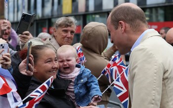 The Prince of Wales meets members of the public after his visit to the East Belfast Mission at the Skainos Centre