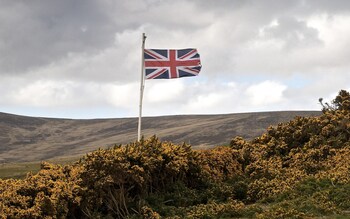 The Union Flag flies high over the British War Cemetery at San Carlos, Falkland Islands