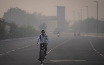 A cyclist rides amid smog in New Delhi, India, Tuesday, Nov. 7, 2023