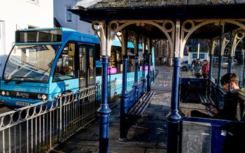 An Arriva bus leaves the bus stop outside Conwy town centre station, on October 2021, in Conwy, Gwynedd, Wales.