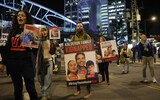 People protest to stress their call on the government to sign an agreement with Hamas for a release of hostages outside the Kirya military base in Tel Aviv